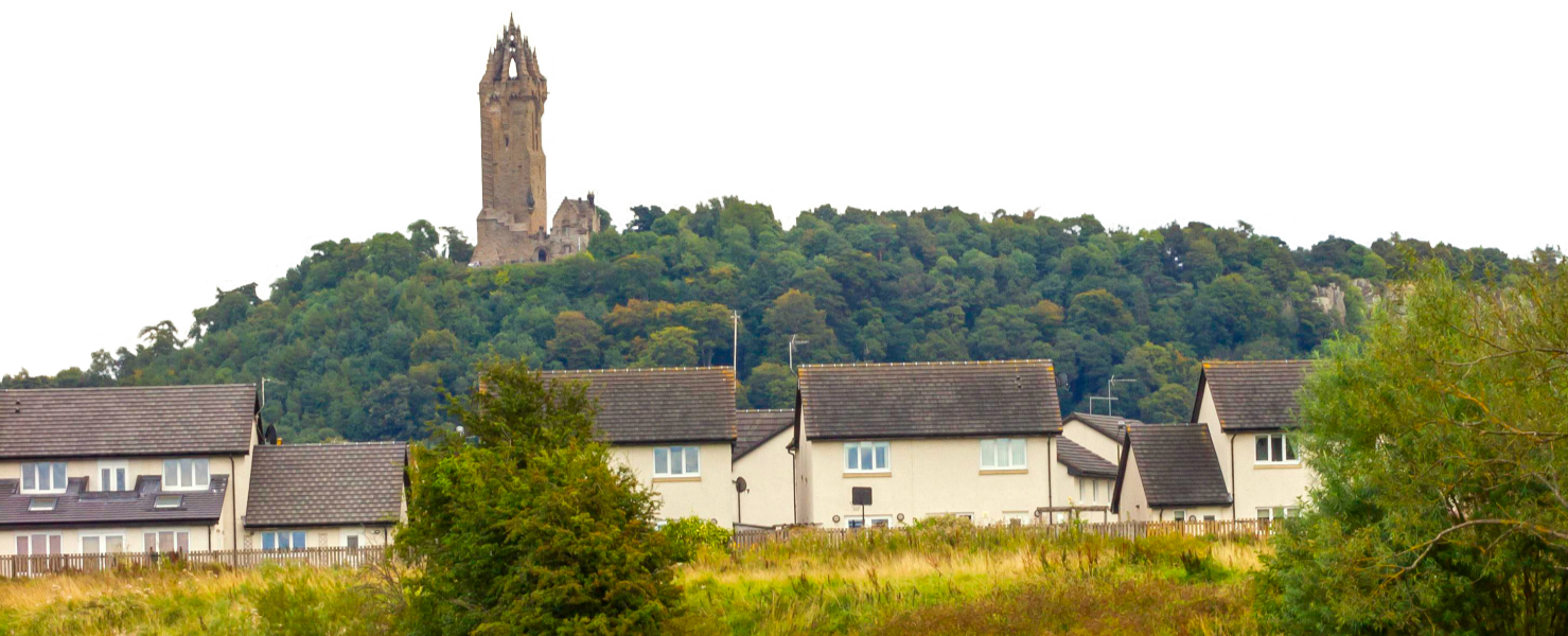 Photo showing some houses in Stirling with the Wallace Monument in the background