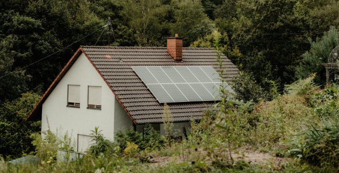 A rural house with solar panels on it's roof