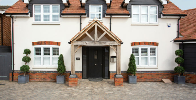 A white house with red brick features, showcasing an immaculate facade.